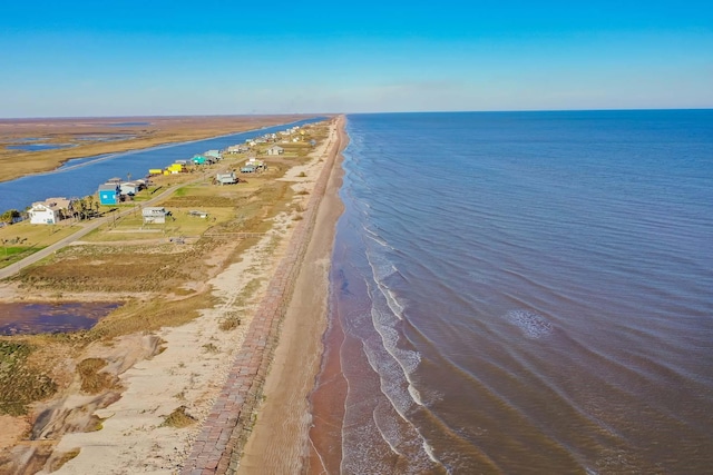 drone / aerial view featuring a water view and a view of the beach