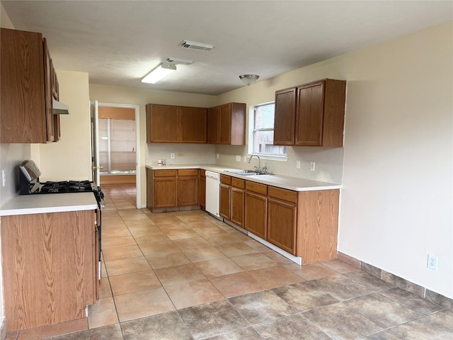 kitchen featuring white appliances and sink