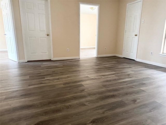 spare room with dark hardwood / wood-style flooring