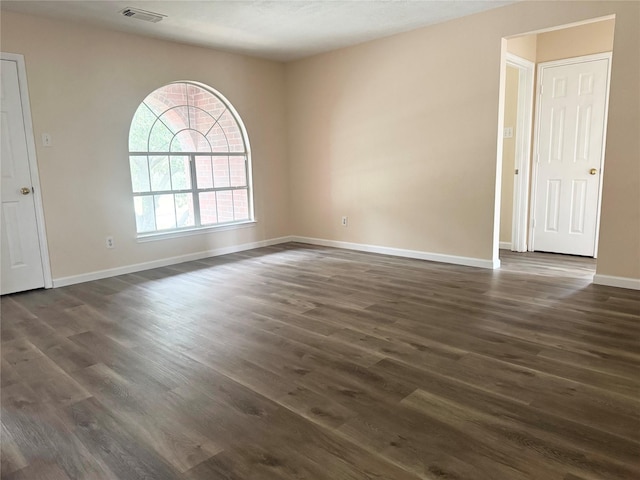 spare room featuring dark hardwood / wood-style floors