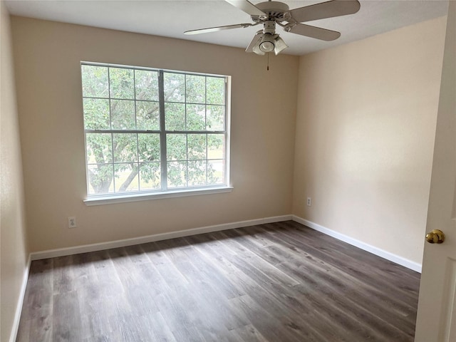 spare room featuring ceiling fan, a healthy amount of sunlight, and dark hardwood / wood-style floors