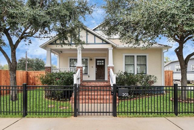 view of front of property with covered porch and a front lawn