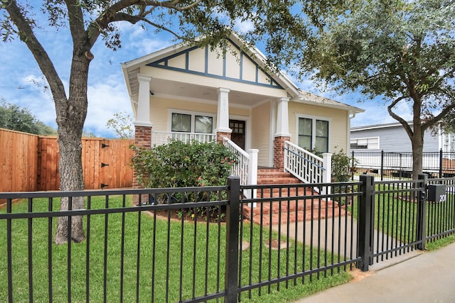 view of front of home with covered porch and a front yard