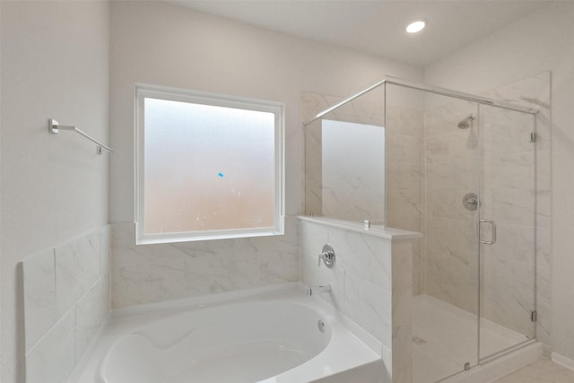 bathroom featuring plenty of natural light and plus walk in shower