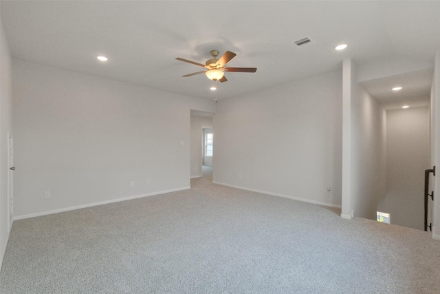 spare room featuring ceiling fan and carpet