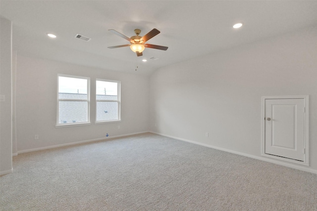 carpeted spare room with ceiling fan and lofted ceiling