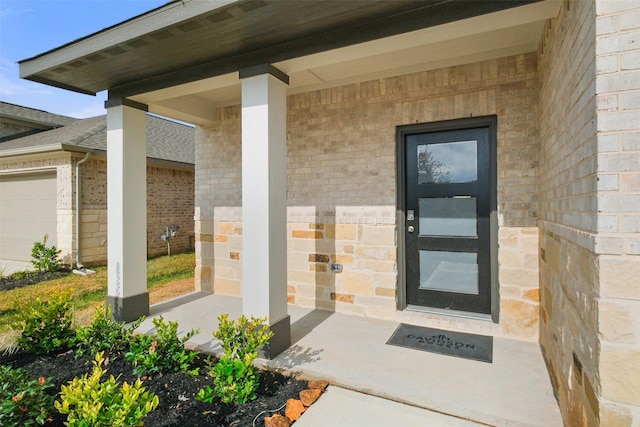 doorway to property with a porch and a garage