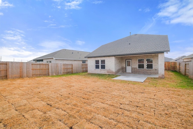 rear view of property featuring a yard and a patio