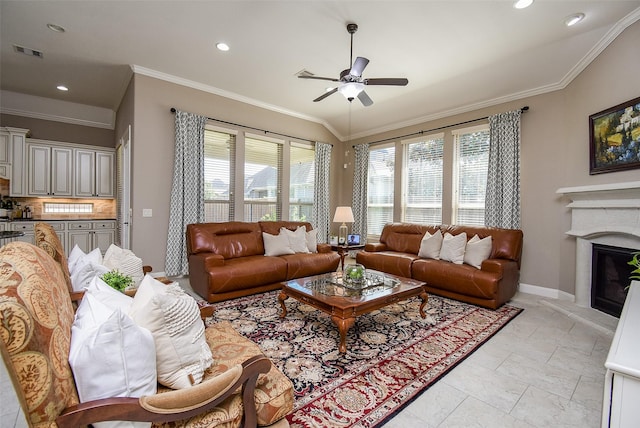 living room featuring ceiling fan, ornamental molding, and a wealth of natural light