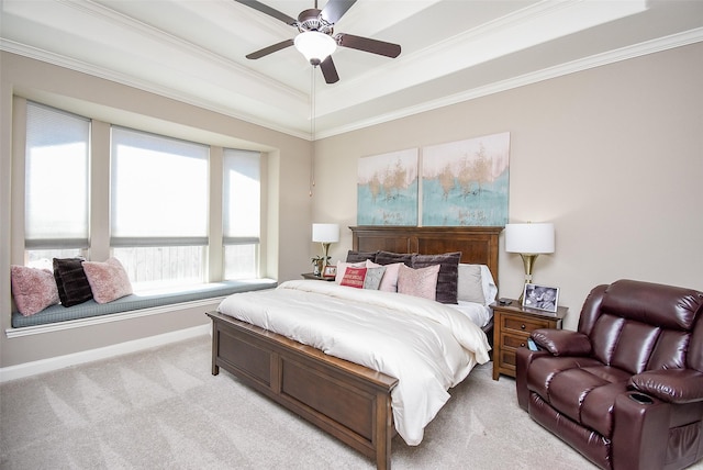 carpeted bedroom featuring a tray ceiling, ceiling fan, and ornamental molding