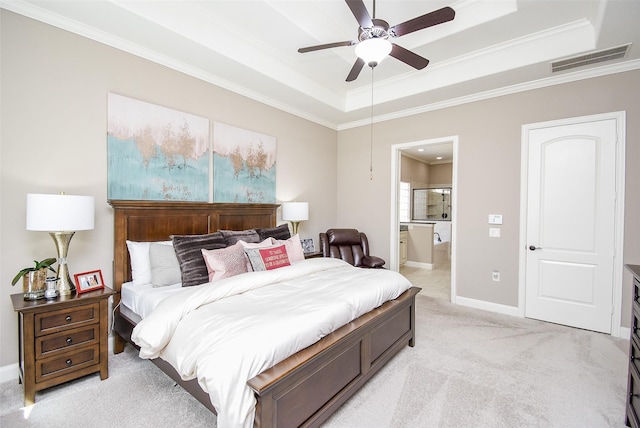 carpeted bedroom with ceiling fan, a raised ceiling, ornamental molding, and connected bathroom