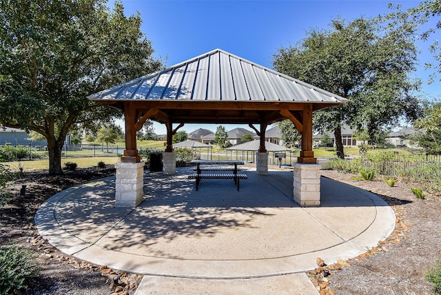 surrounding community with a gazebo and a patio area