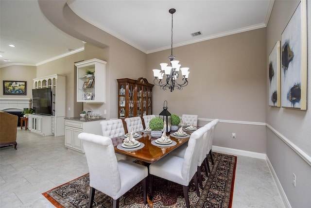 dining room with ornamental molding and a chandelier