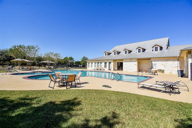 view of pool featuring a yard and a patio