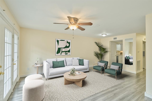 living room with ceiling fan and hardwood / wood-style floors