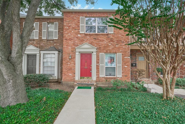 view of property featuring brick siding