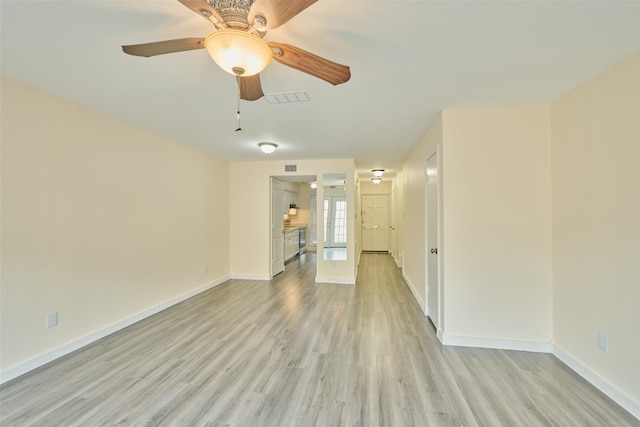 empty room with french doors, ceiling fan, and light hardwood / wood-style flooring