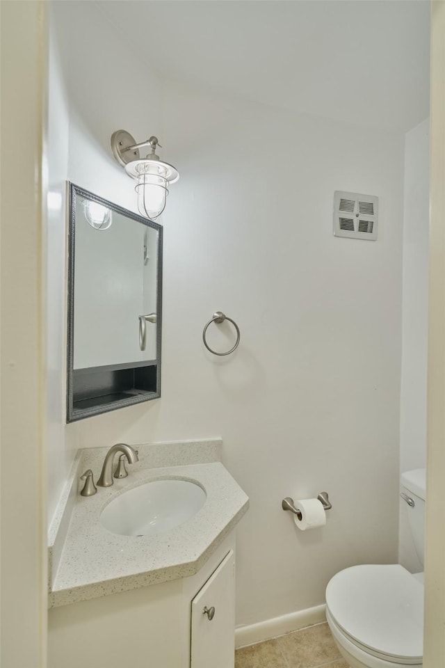 bathroom with vanity, tile patterned floors, and toilet