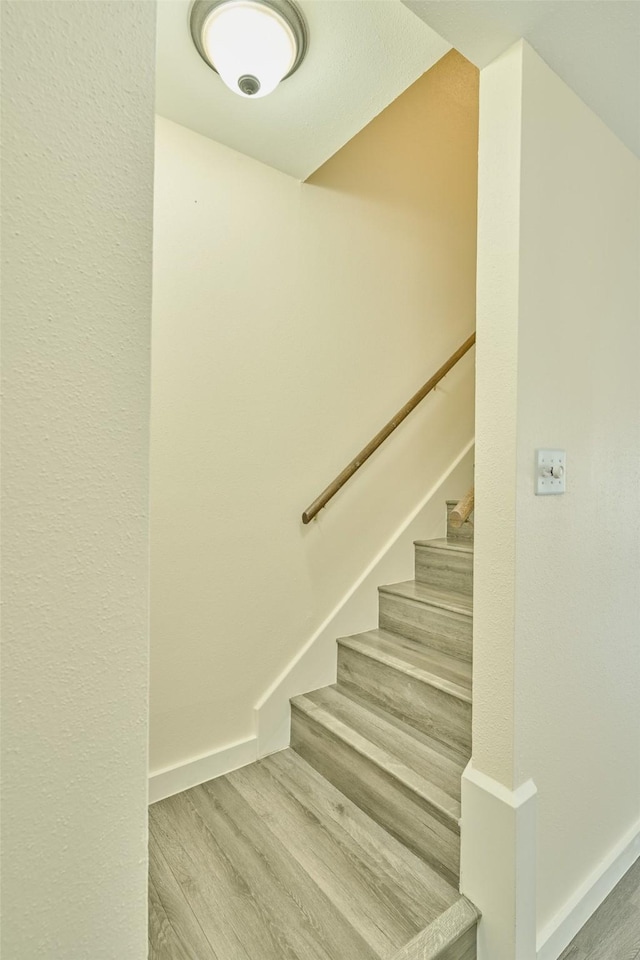 stairs with hardwood / wood-style flooring