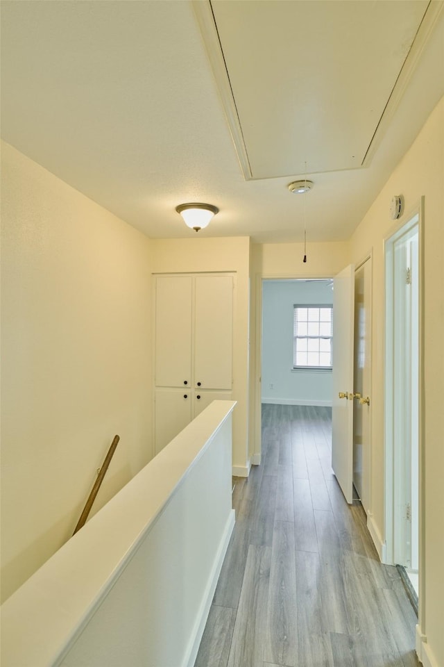 corridor with light hardwood / wood-style floors