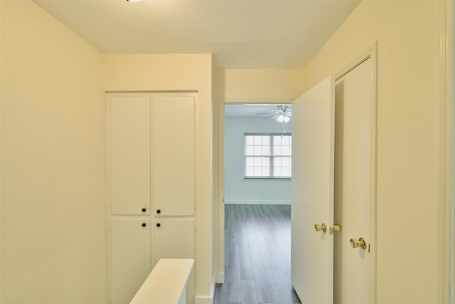 hallway with hardwood / wood-style floors and a textured ceiling