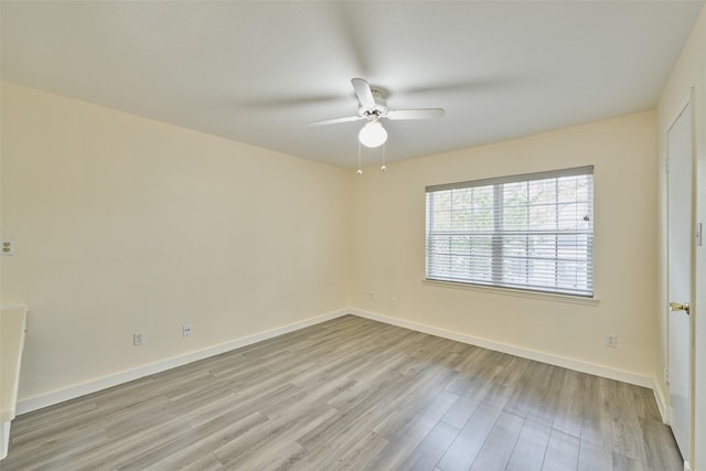 empty room with ceiling fan and light hardwood / wood-style floors