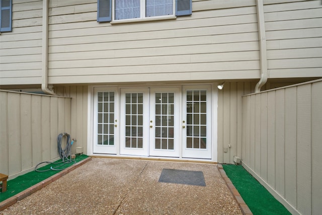 property entrance with a patio area and french doors