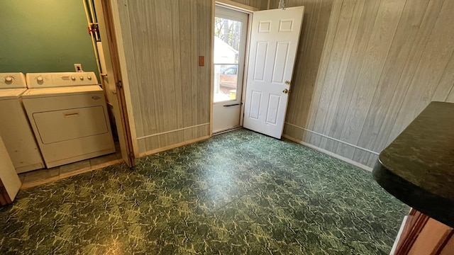 interior space featuring washer and dryer and wooden walls