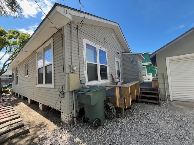 rear view of house featuring a wooden deck