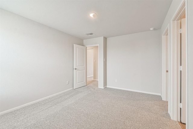 unfurnished bedroom featuring light carpet