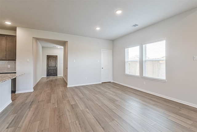 unfurnished living room featuring light hardwood / wood-style flooring