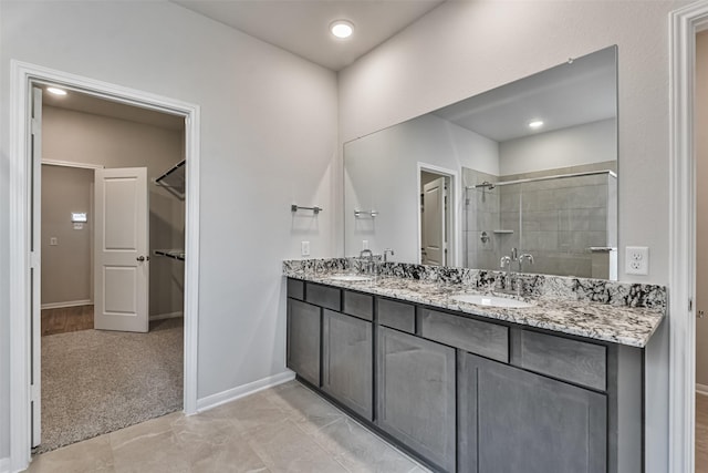 bathroom with vanity and a shower with door