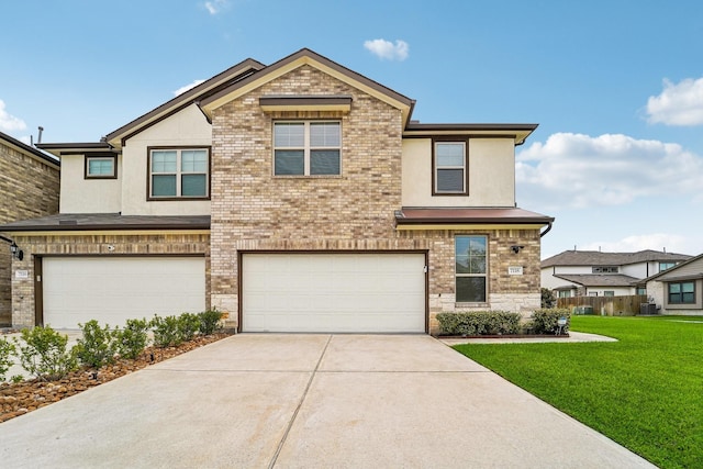 view of front of property with a front yard and a garage