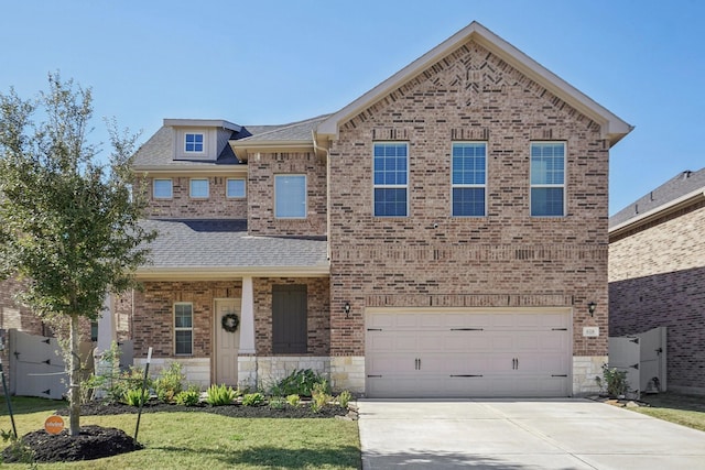 view of front facade featuring brick siding, a shingled roof, concrete driveway, stone siding, and a front lawn