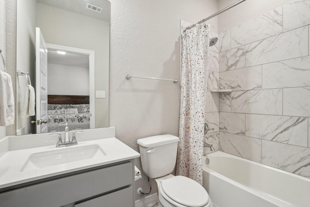 full bathroom featuring vanity, toilet, and shower / bath combo