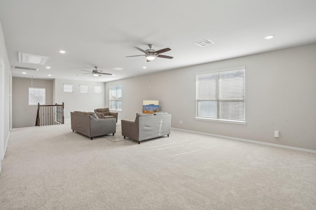 carpeted living room featuring ceiling fan and a healthy amount of sunlight