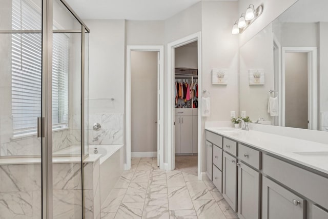 bathroom featuring vanity and independent shower and bath