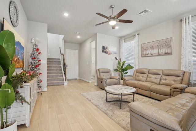 living room featuring ceiling fan and light hardwood / wood-style flooring