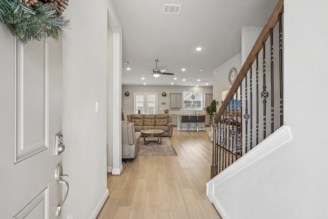 entryway featuring ceiling fan, sink, and light hardwood / wood-style flooring