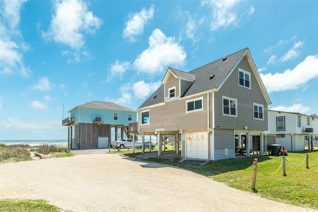 view of front of home with a water view, central AC, and a front lawn