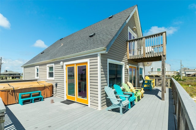 wooden terrace featuring a hot tub