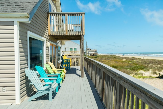 deck featuring a beach view and a water view