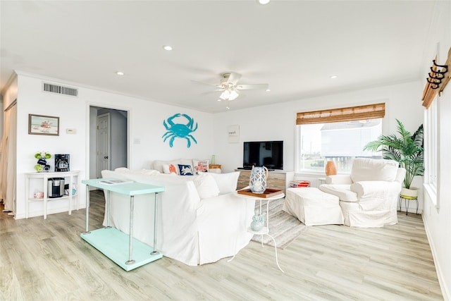 living room with ceiling fan, light hardwood / wood-style flooring, and ornamental molding