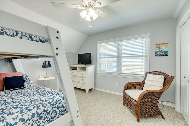 bedroom with ceiling fan, vaulted ceiling, light colored carpet, and a closet