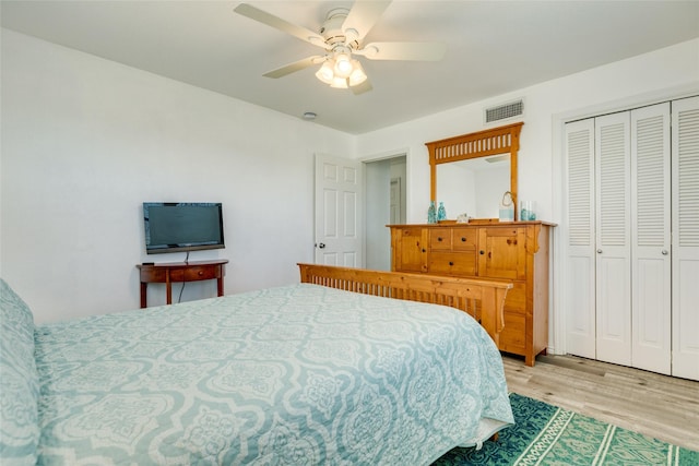 bedroom featuring ceiling fan, light hardwood / wood-style flooring, and a closet