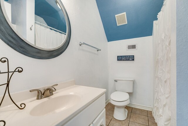 bathroom featuring tile patterned floors, vanity, and toilet