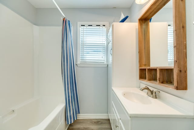 bathroom featuring hardwood / wood-style floors, vanity, and shower / bath combo with shower curtain