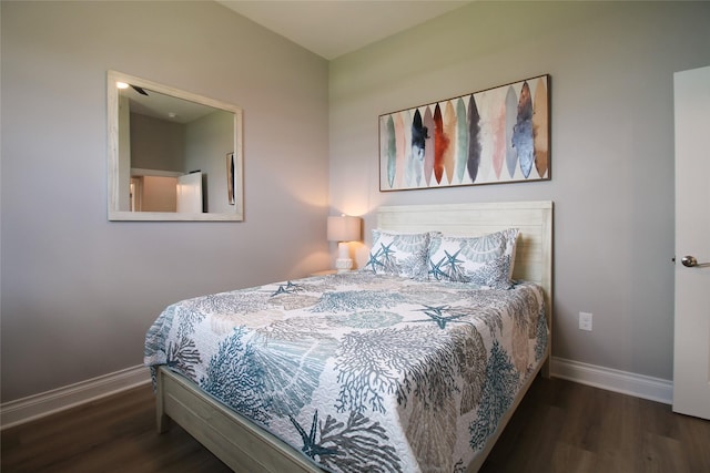 bedroom with dark hardwood / wood-style flooring