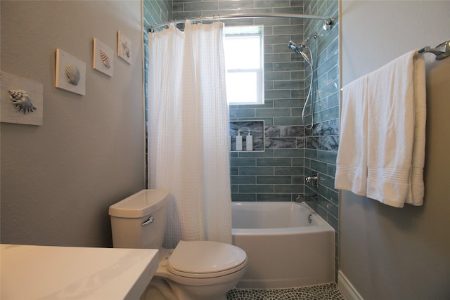 bathroom with shower / tub combo and toilet