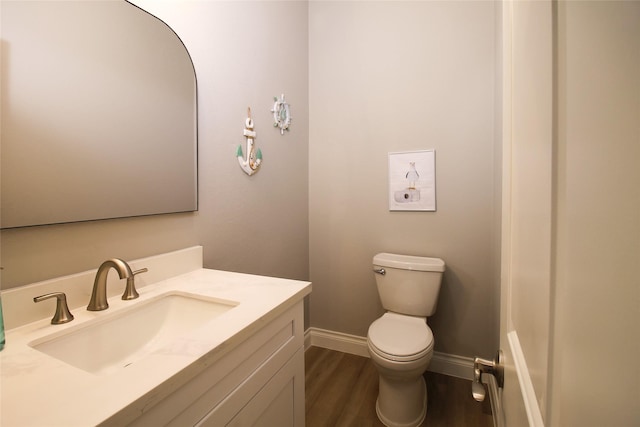 bathroom with vanity, hardwood / wood-style flooring, and toilet